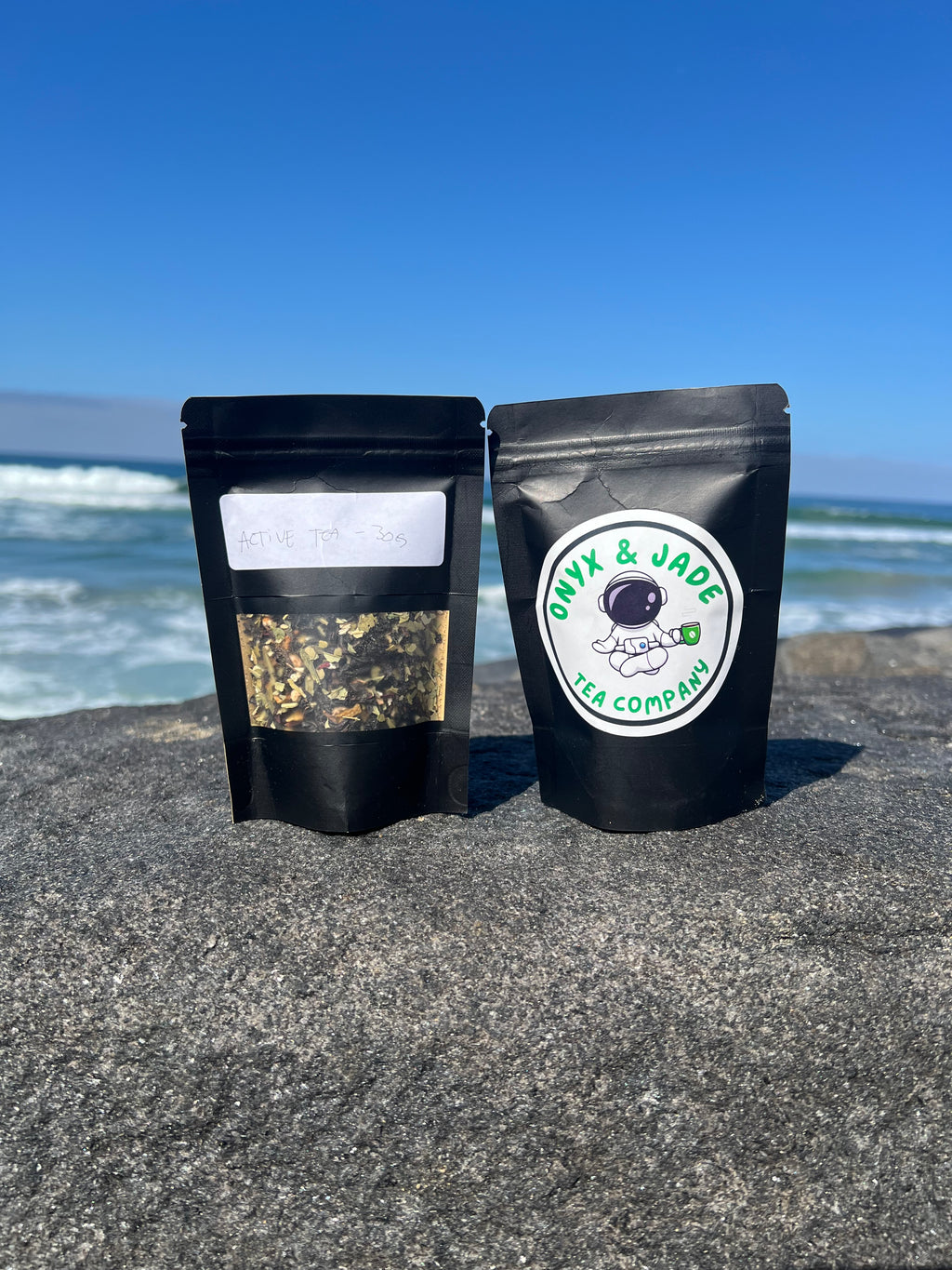 Front and back of the Onyx & Jade Tea Company Active Tea package showing the product label, ingredients, caffeine information, preparation directions, and package details.