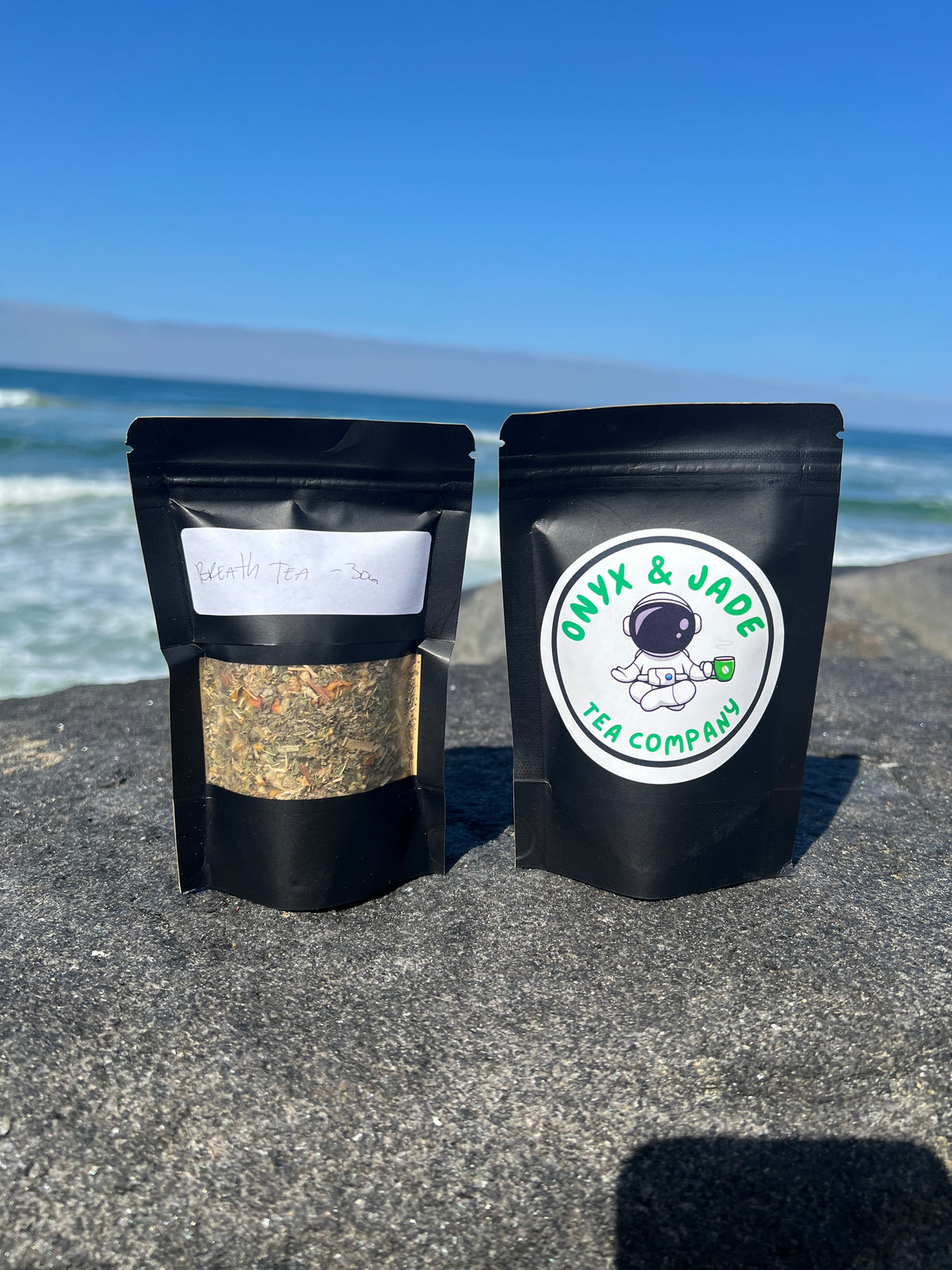 Front and back of the Onyx & Jade Tea Company Breath Tea package showing the product label, ingredients, preparation directions, fine straining notice, and package details.