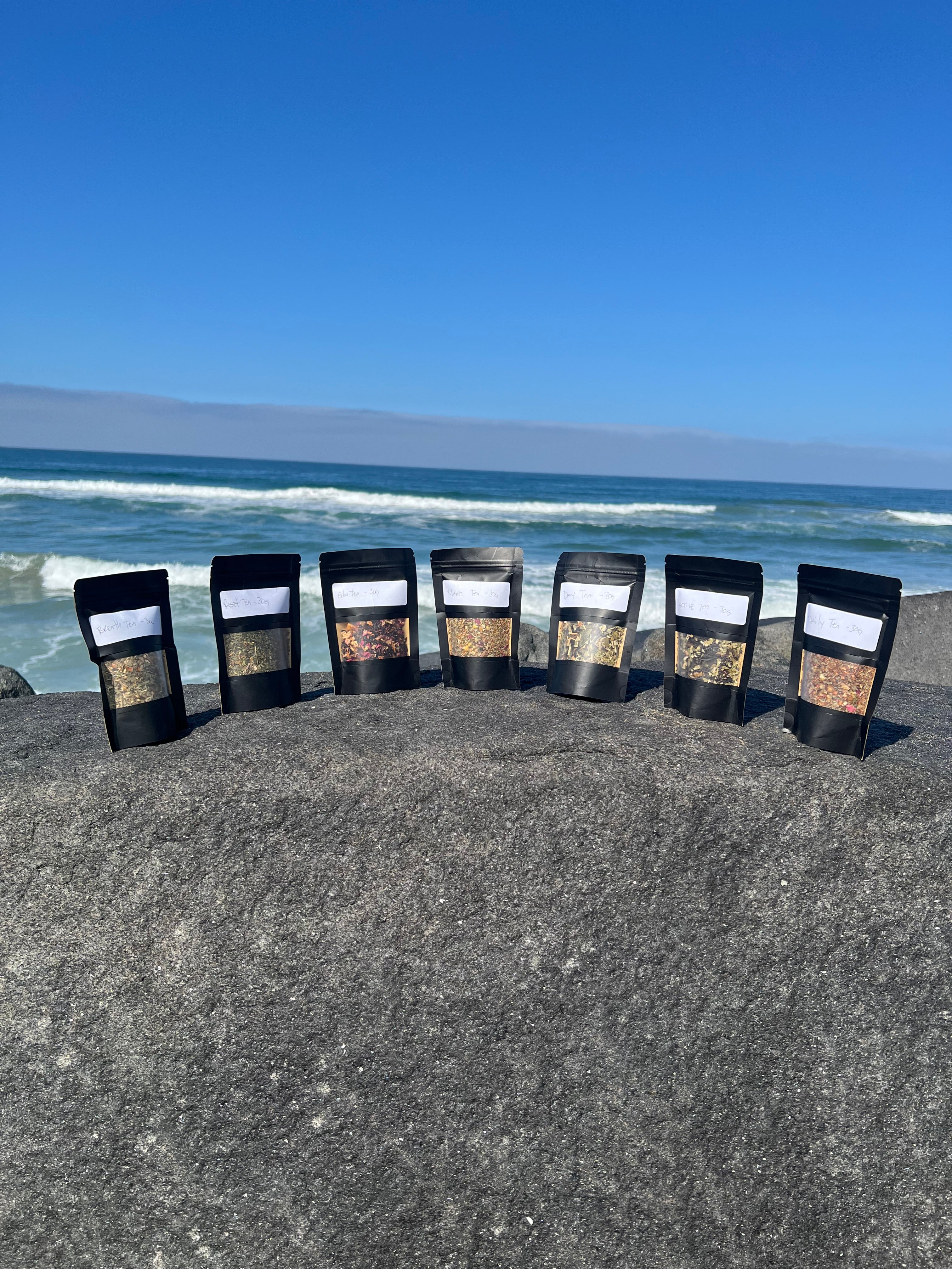 Founder’s Starter Bag Kit from Onyx & Jade Tea Company featuring seven original loose-leaf tea pouches and one 12 oz jar of Pure Honey displayed together.