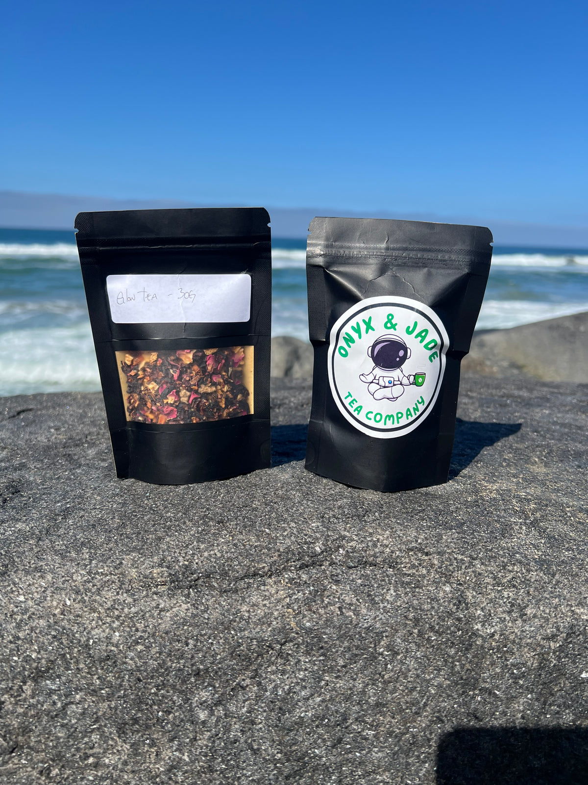 Front and back of the Onyx & Jade Tea Company Glow Tea package showing the product label, ingredients, caffeine information, hot and iced preparation directions, and package details.