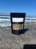 Onyx & Jade Tea Company Reset Tea pouch, featuring a caffeine free roasted dandelion and burdock root blend with peppermint, ginger, nettle, citrus, and spice.